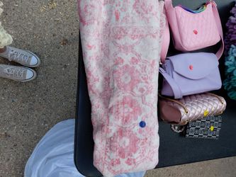 Pink rug, bed runner, and blanket
