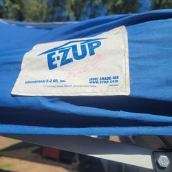blue pop-up canopy, likely an E-Z UP
