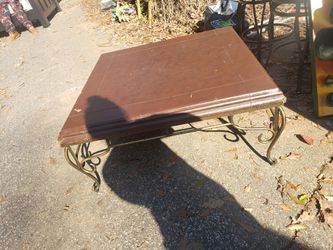 Coffee table with leather type top does have tear in top. Make offer