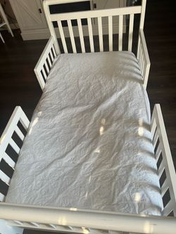 White Toddler bed with ikea mattress covered with mattresses protection pad. Never soiled clean smoke free home