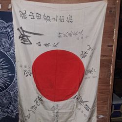 The flag, known as "Yosegaki Hinomaru," or Good Luck Flag