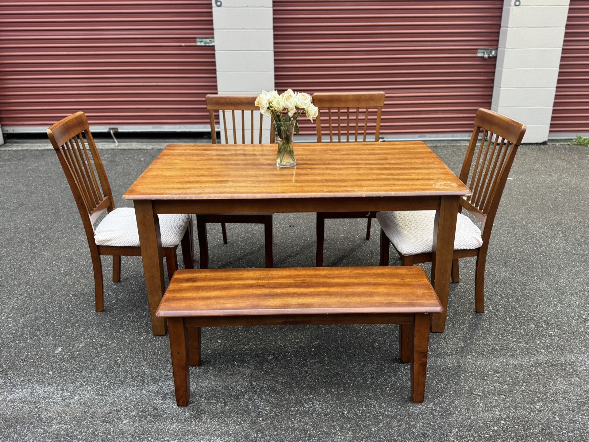Wooden table and four chairs and a bench