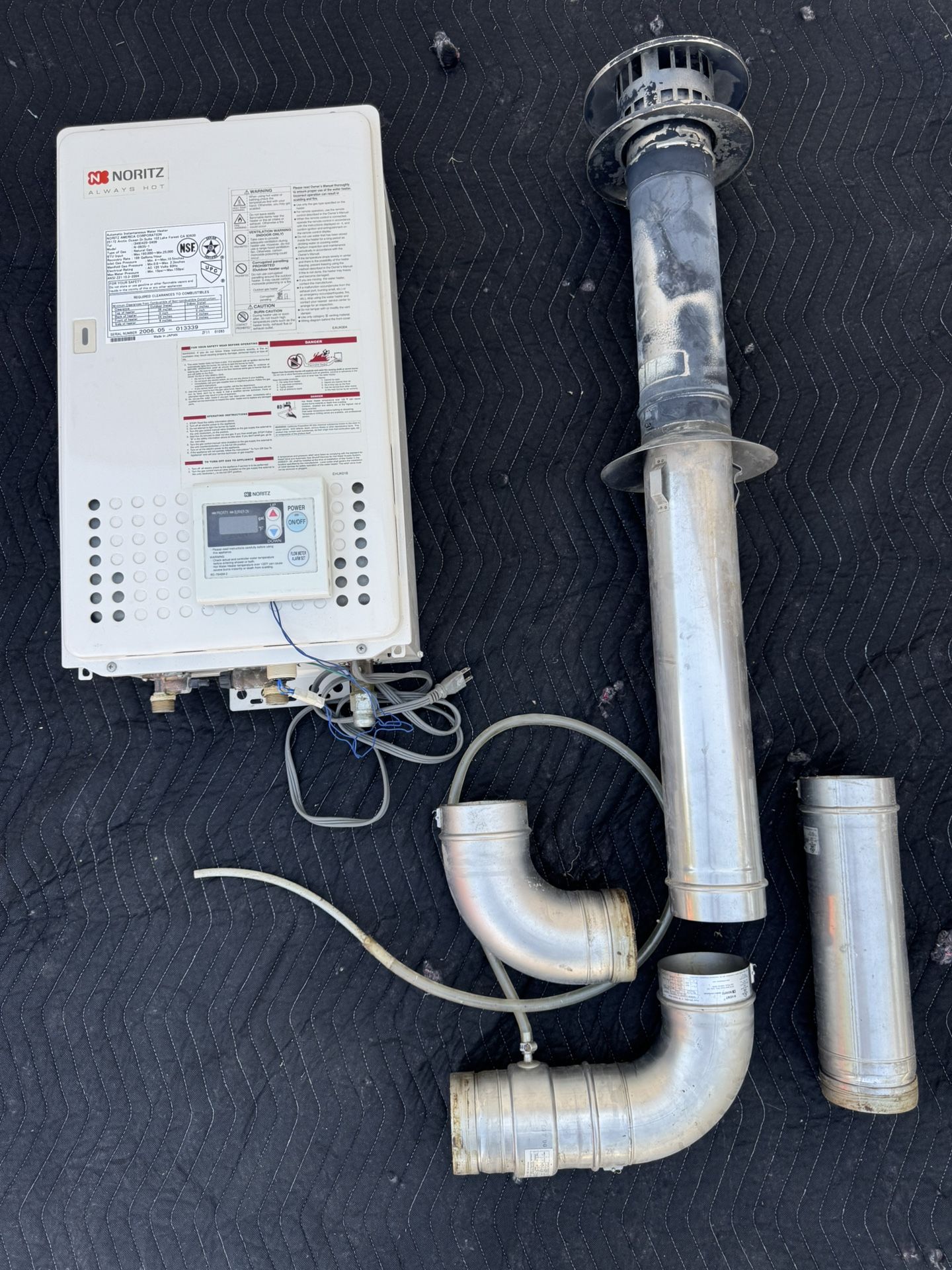 Noritz tankless natural gas hot water heater, with vent pipe