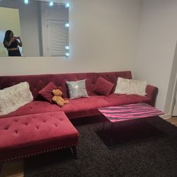 Couch Wine Color, Black Rug, And Coffee Table