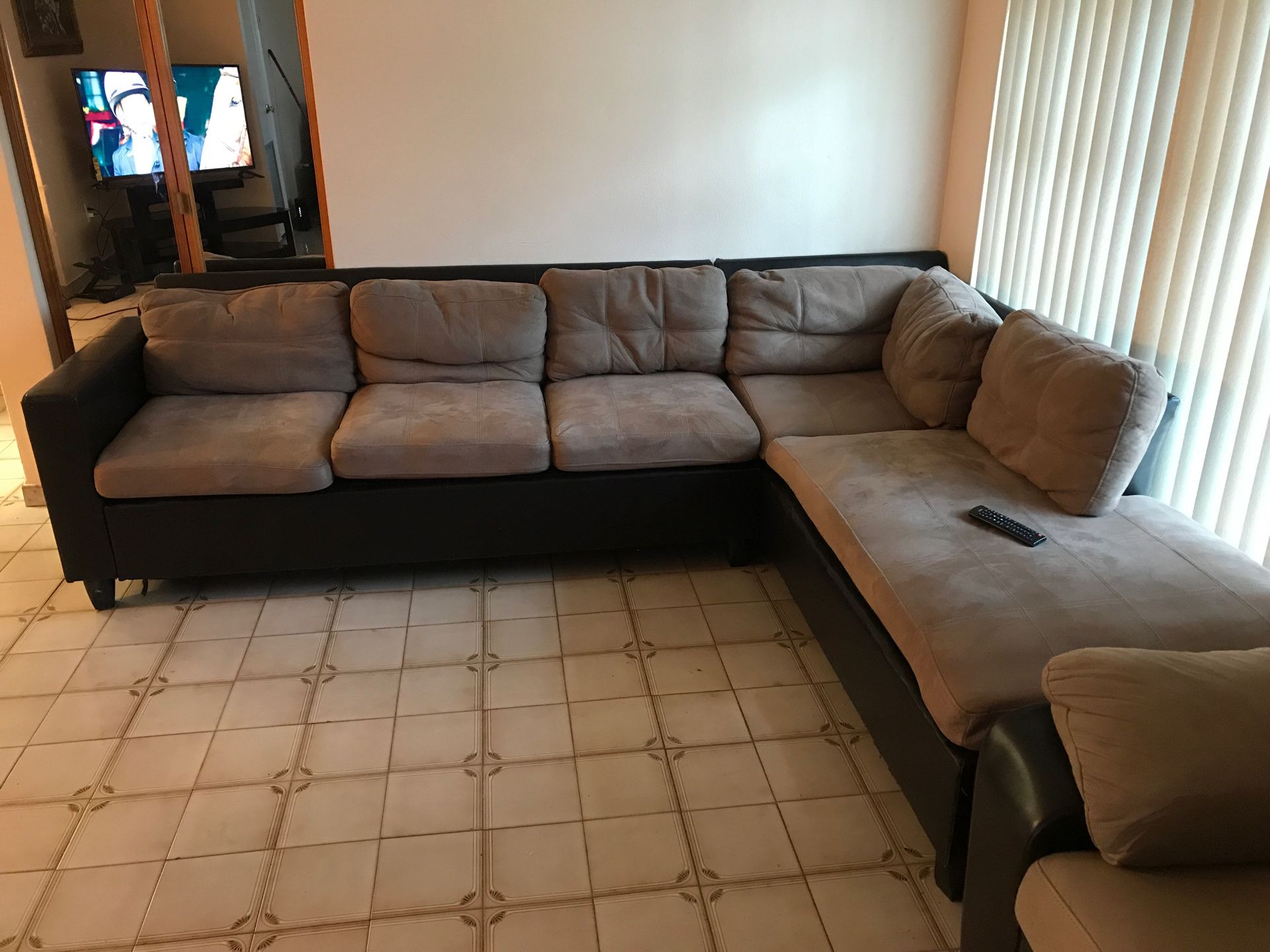 Brown sectional and love seat