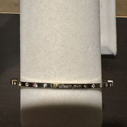 Beautiful gold tone Michael Kors bangle bracelet with rhinestones.