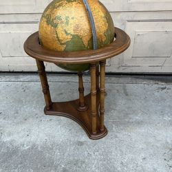 VINTAGE WORLD GLOBE WITH MUTED COLOR AND WOODEN STAND