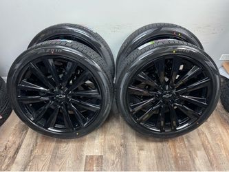 NEW 24 inch gloss black Gm style wheels wrapped in atturo 285/40r24 tires.