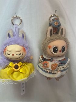 2 Pop Mart Labubu vinyl plush doll pendants. “Fall In Wild”, Have A Seat,”Uzi”