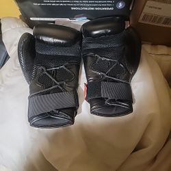 This is a pair of black and white Adidas Hybrid 250 Duo Lace boxing gloves