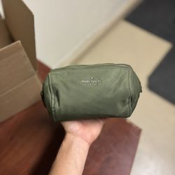 Green Kate Spade New York cosmetic bag
