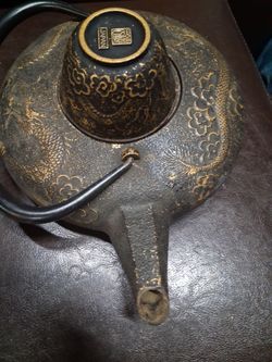Cast iron tea pot and cup