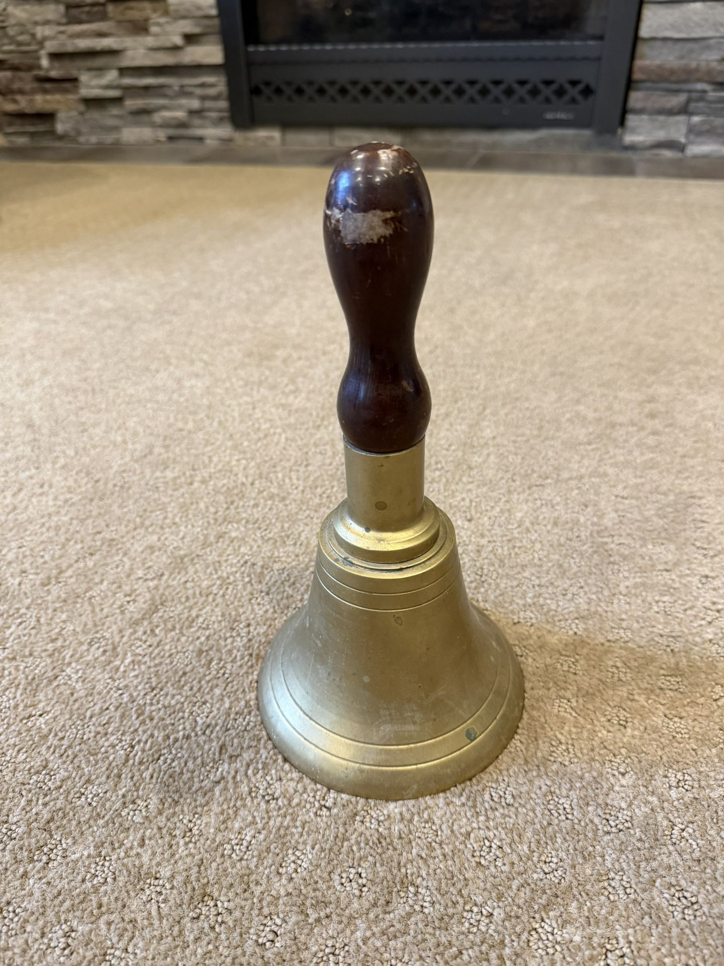 Vintage brass hand bell with a solid wood handle