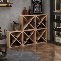 Natural pine wood wine rack cube has an X-shaped divider design for bottle storage. This modular rack allows for stacking multiple units together. It 