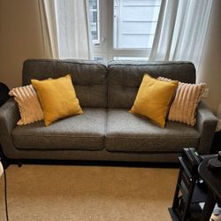Comfy Grey Couch + Pillows In Listing 