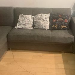 Istakbaal L shaped Couch cum bed with storage and an upholstered ottoman.