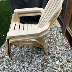 Two Tan Plastic Chairs