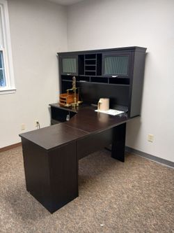 Black executive office desk with cabinets and drawers