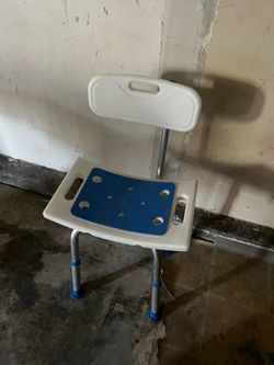 white and blue adjustable shower chair with a removable backrest