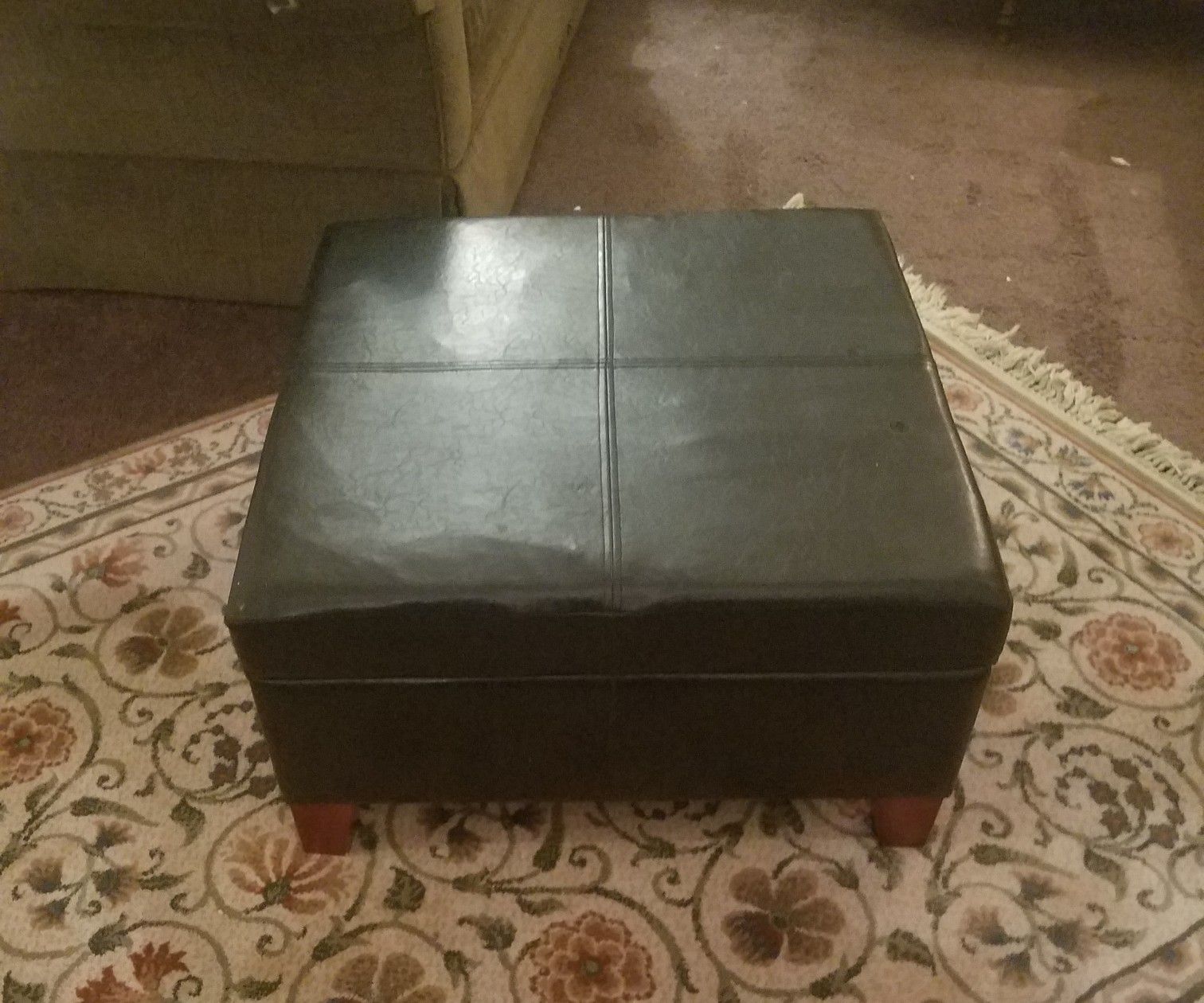 Ottoman with storage... small burn hole in the top barely noticeable leather material