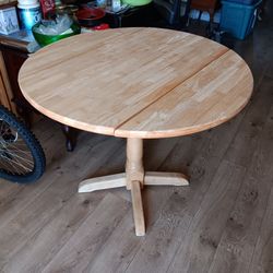 Round single pedestal drop leaf table