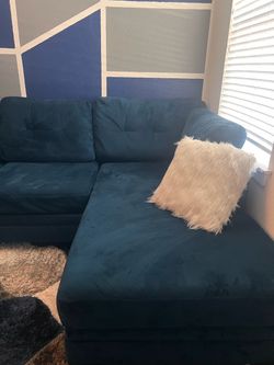 Blue sectional with rug and chair