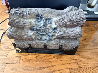 a vintage electric fireplace log air heater