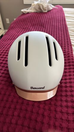 Thousand Rose and White adjustable Bike Helmet with a reflector.