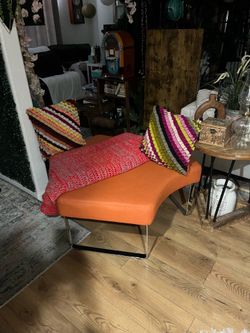 Beautiful artsy modern orange leather ottoman with chrome legs in perfect condition 42”x16”