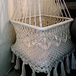 Hanging macrame baby bassinet