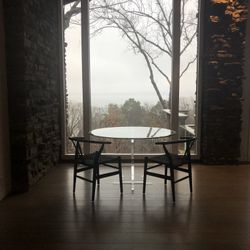 52” Round Beveled Glass Top Table with Acrylic Base and (4) Hans Wegner Wishbone Style Black Chairs 