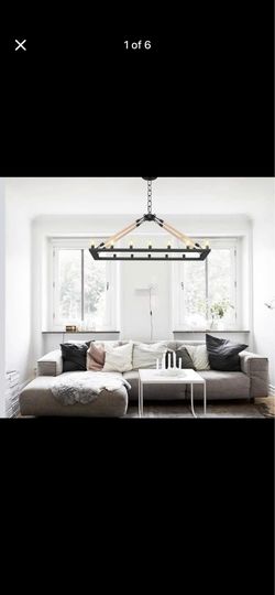 Industrial 16-light chandelier is made of iron with a black finish and features decorative rope-wrapped connection rods. This rectangular fixture meas