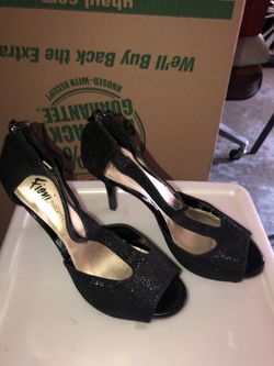 Size 8.5 shimmery black high heel shoes that zip up the back. Barely worn