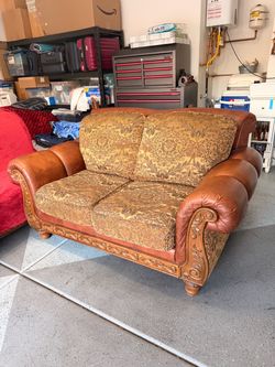 Leather and Fabric Loveseat with Carved Wood Frame