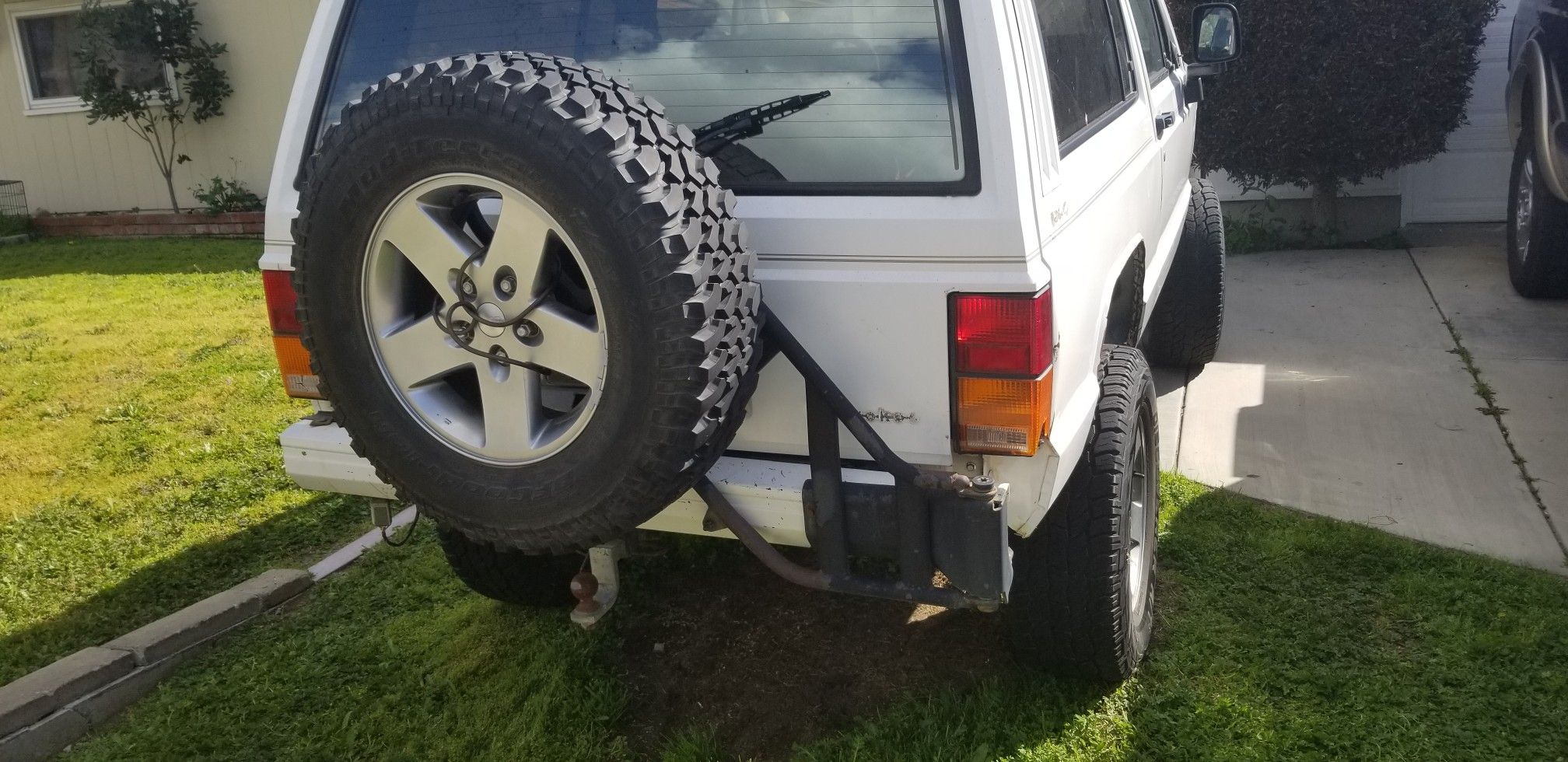 Jeep cherokee xj, OEM spare tire carrier.