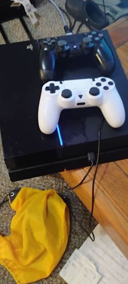 PlayStation 4 with two wireless remotes