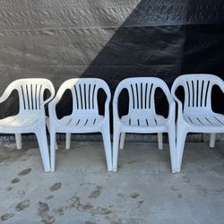 4 White Plastic Chairs