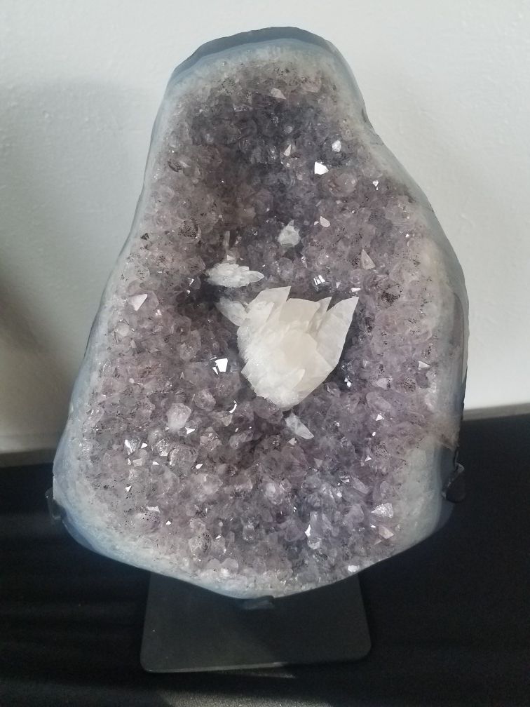 Amethyst crystal with calcite tooth
