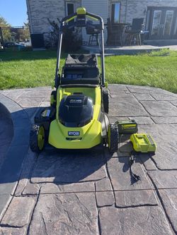 Brand new 20 inch Ryobi lawnmower with a 6.0 battery and a fast charger