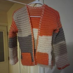 hand crocheted medium sweater with pockets. the sweater is soft and cozy!