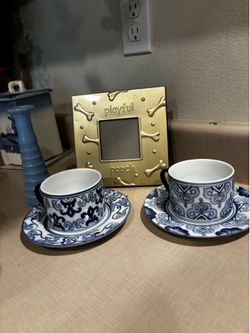 2 blue and white cups and saucers vintage