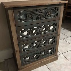 Beautiful wooden dresser with intricate carvings.