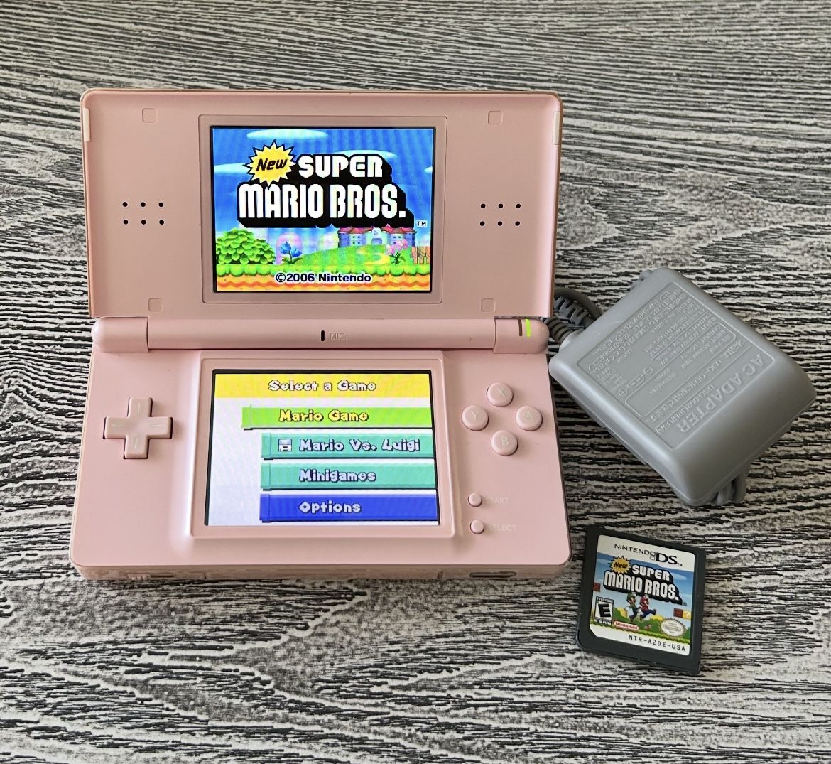 Pink Nintendo DS with Super Mario Bros. game in excellent condition. $65