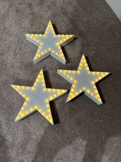 Three wooden star lights