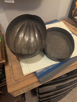 vintage or antique steamed pudding mold, likely made of tin or zinc