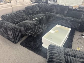 Plush corduroy black large power reclining sectional with surround sound.