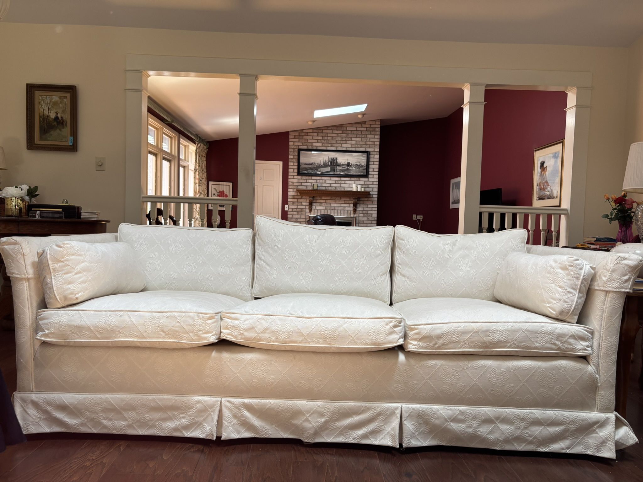 White Couch With feather filled pillows.