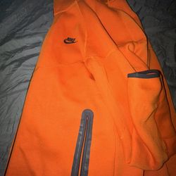 orange nike tech zip up