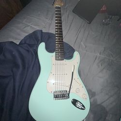 Squier Fender, Stratocaster electric guitar, tealish light blue