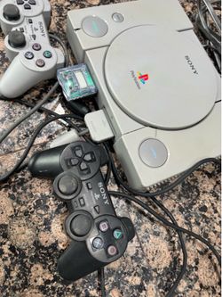 PlayStation 1 with two controllers, memory card and game
